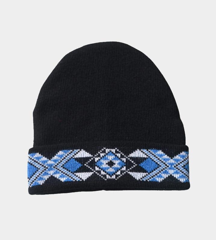 Black knitted beanie with blue and white Māori Tāniko design stitched into the turned up band.
