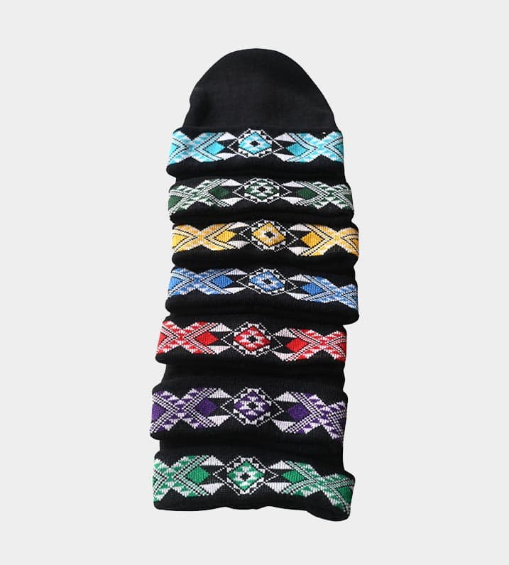 Black knitted Māori beanies showcasing Kapa Haka Makers' distinctive Tāniko designs in aqua, dark green, yellow, blue, red, purple, and green.