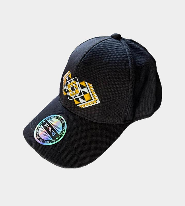Black Māori pōtae cap showcasing Kapa Haka Makers' distinctive yellow Tāniko design embroidered onto the front.